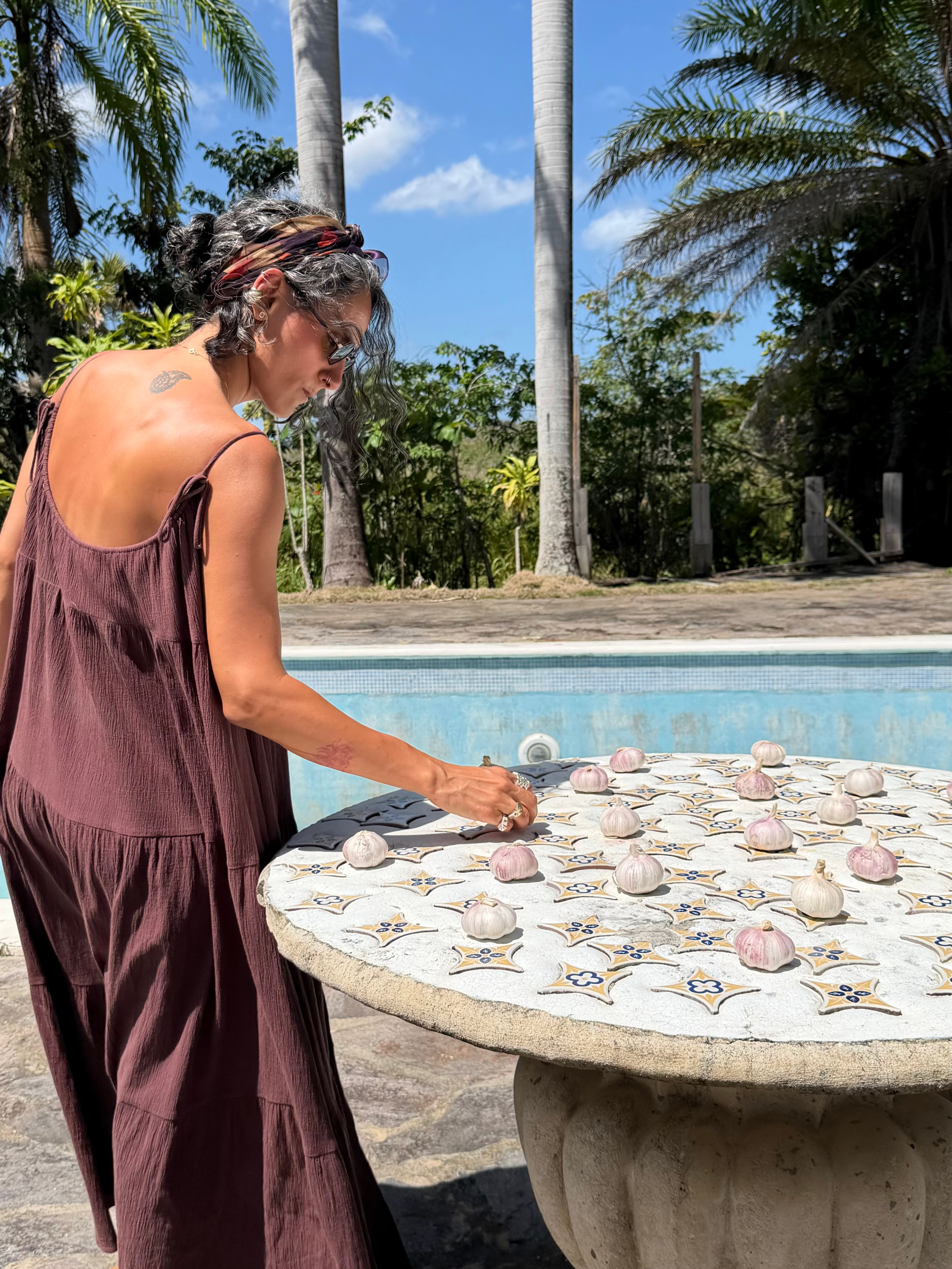 Ava arranging a table by the pool